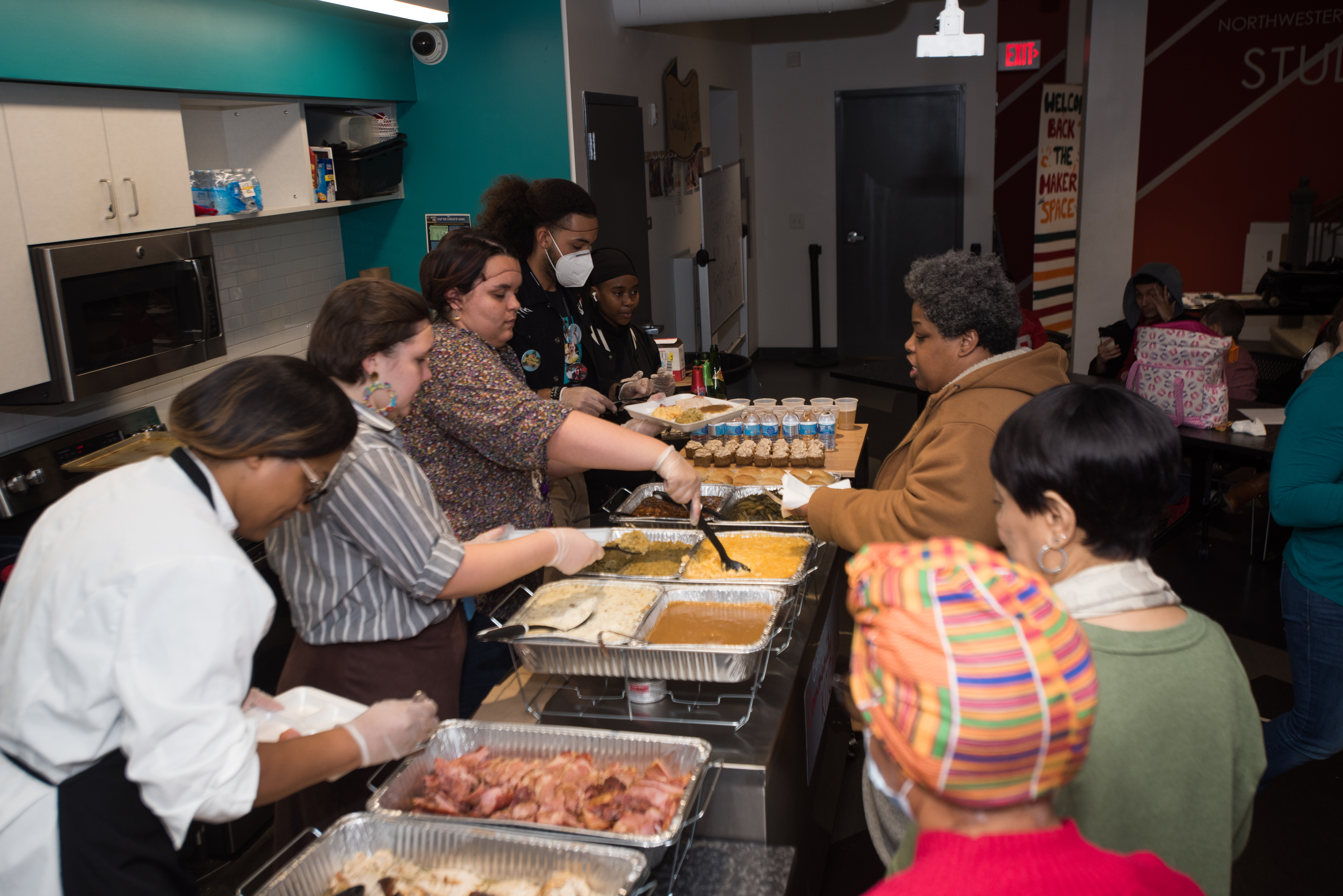People being served a holiday meal from the kitchen